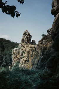 Low angle view of rock formation against sky