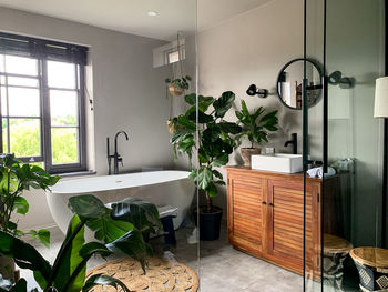 Charming cozy bathroom view. bath tube by the window. taking bath at home or in a hotel. charming