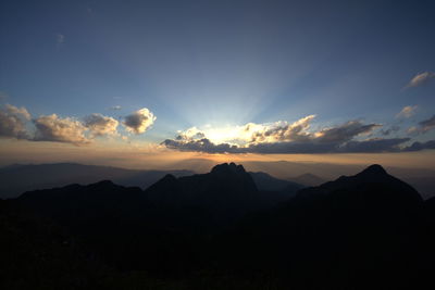 Scenic view of silhouette mountains against sky at sunset