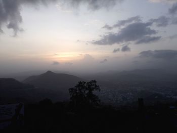 Scenic view of silhouette mountains against sky at sunset