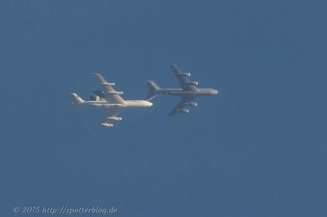 flying, low angle view, air vehicle, blue, airplane, transportation, clear sky, mode of transport, copy space, mid-air, travel, day, outdoors, no people, on the move, sky, motion, journey, flight, nature