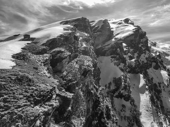 Panoramic view of rock formation in sea against sky
