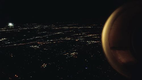 Close-up of illuminated cityscape against sky at night