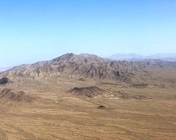 Scenic view of mountains against clear blue sky