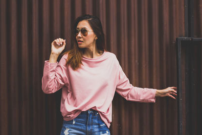 Young woman wearing sunglasses standing outdoors