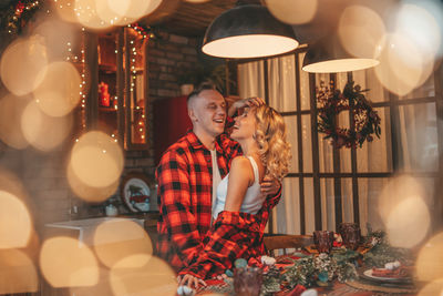 Candid authentic happy married couple spends time alone at lodge xmas decorated