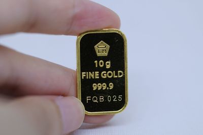 Close-up of hand holding text against white background