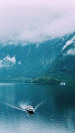 Transportation vessel on the foggy austrian lake.