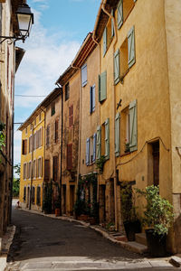 Street amidst buildings against sky