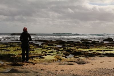 Rear view of man standing on beach