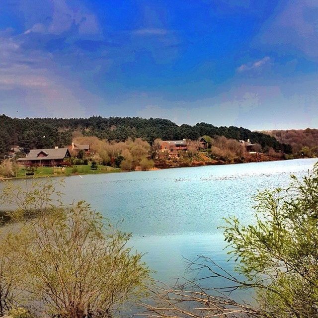 water, blue, sky, built structure, scenics, tranquility, tranquil scene, architecture, mountain, sea, building exterior, beauty in nature, nature, house, high angle view, town, tree, idyllic, day, lake