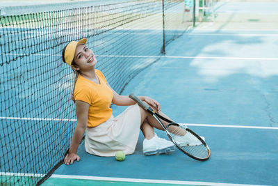 Portrait of young woman playing tennis