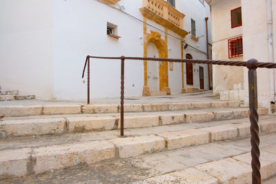 Staircase by wall of old building