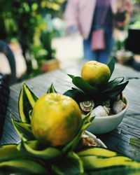 Close-up of fruits and leaves on table