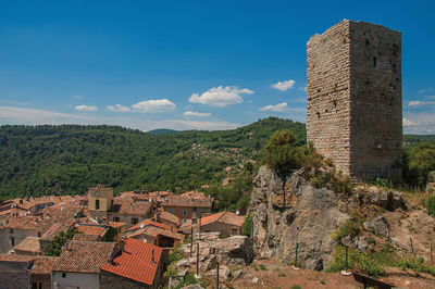 Panoramic view of tower on top of hill with chateaudouble underneath, in the french provence.