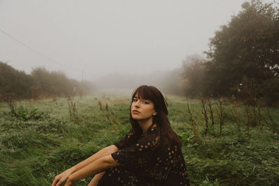 Portrait of woman sitting by plants