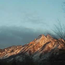 Low angle view of snowcapped mountain against sky