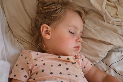 Peaceful adorable baby sleeping on a bed at home. slumbering little child. two year old girl sleeps