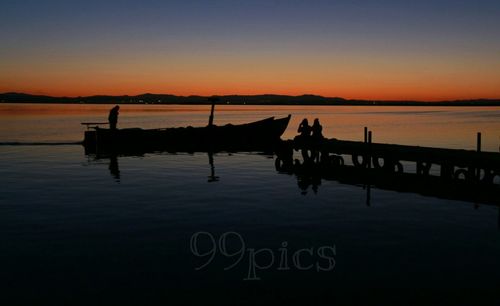 Scenic view of lake at sunset