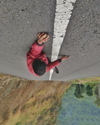 High angle view of man walking on road