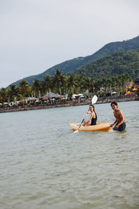 Man kayaking in sea