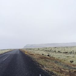 Road by landscape against clear sky