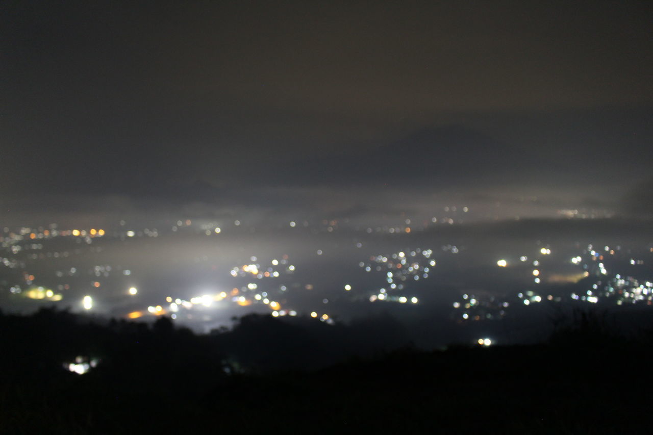 HIGH ANGLE VIEW OF ILLUMINATED CITY AT NIGHT