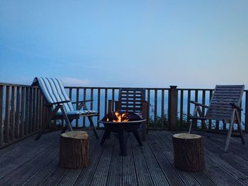 Chairs on beach against clear sky