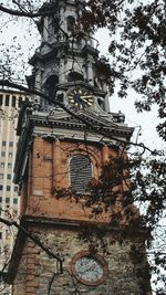 Low angle view of clock tower against sky