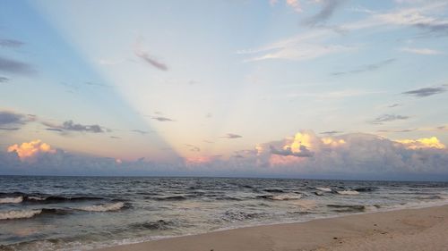 Scenic view of beach against sky during sunset