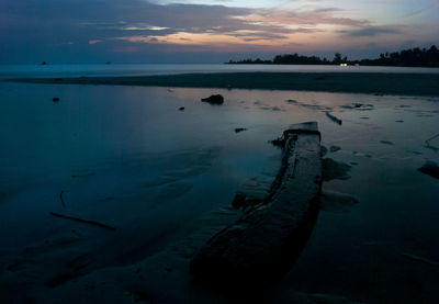 Idyllic view of beach against sky during sunset