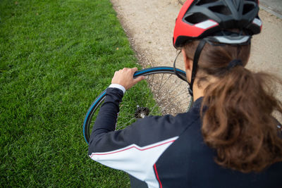 Rear view of woman with bicycle