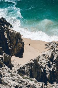 Scenic view of rock formations by beach