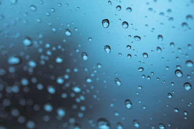 Full frame shot of raindrops on glass window