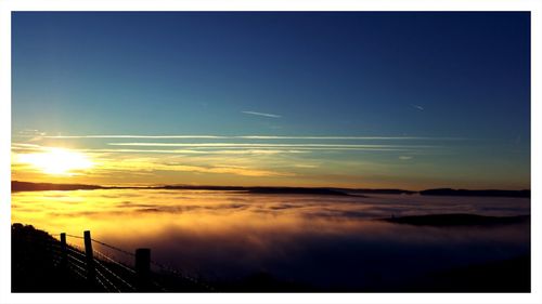 Scenic view of silhouette water against sky at sunset