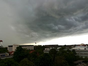 High angle view of residential district against storm clouds
