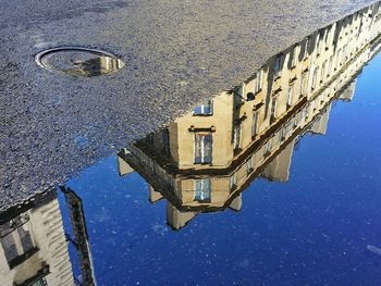 Reflection of buildings in puddle