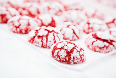 Close-up of baked red cookies on white background