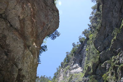 Low angle view of rock formation against sky