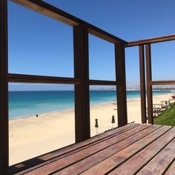 View of beach against clear blue sky