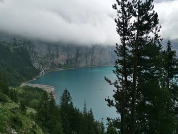 Scenic view of lake by trees against sky