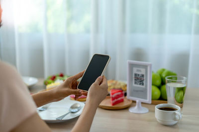 Midsection of man using laptop on table