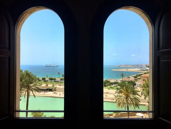 Scenic view of sea seen through glass window