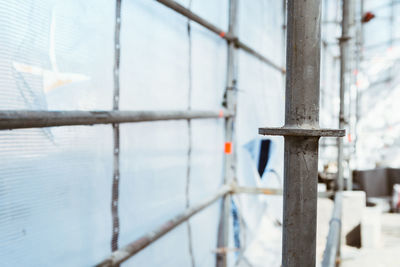 Close-up of metal fence against water