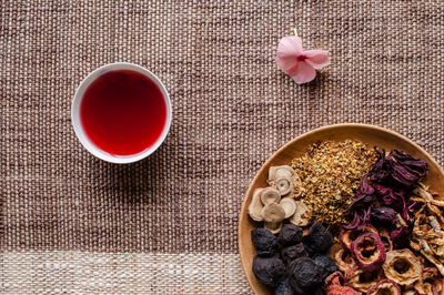 High angle view of potpourri with bowl of aromatic oil on mat