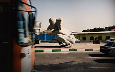 Statue in city against clear sky