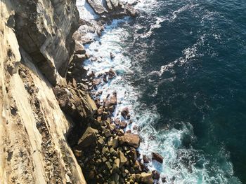 High angle view of rocks on sea