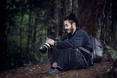 Portrait of photographer in forest