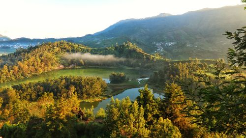 Scenic view of lake and mountains against sky