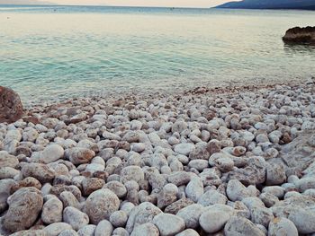 Pebbles on beach against sky